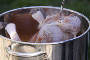 putting turkey into fryer