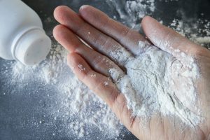 Talcum powder on a hand, main image for johnson & johnson lawsuit blog post