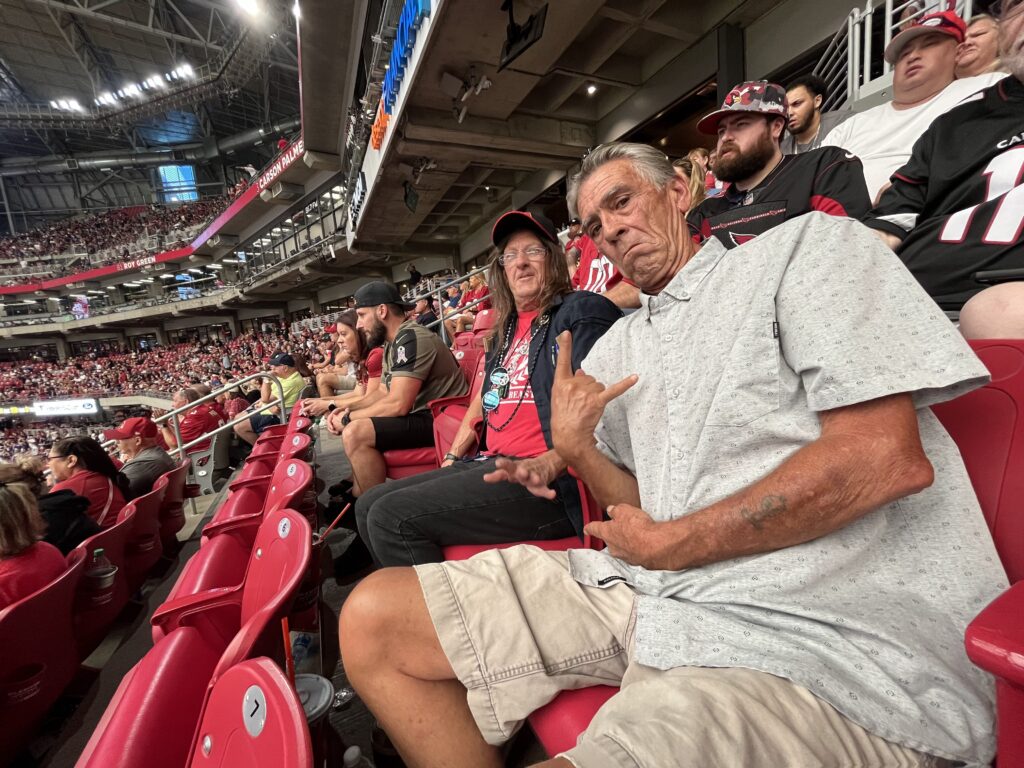 image of individuals in the stands at Arizona Cardinals game for cardinals tickets to veterans blog post