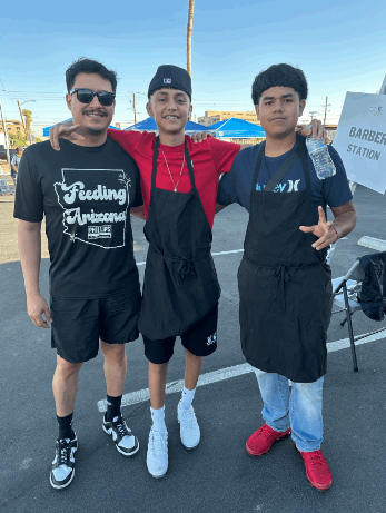 Three volunteers pose at Feeding Arizona event