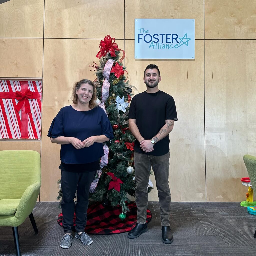 photo of two volunteers in front of a tree at foster alliance