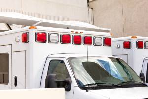 ambulances parked next to stone building