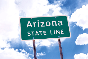 green road sign on arizona state line