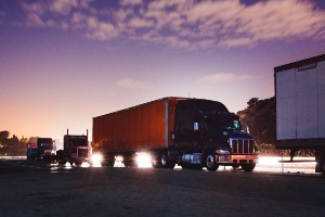 multiple semi-trucks traveling on interstate 