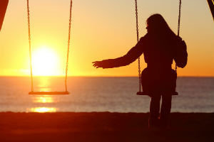 woman with outstretched hand on a swing