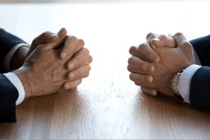 two people sitting across from each other at table
