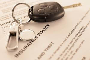 keys resting on insurance documents