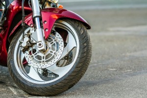 red motorcycle parked on shoulder