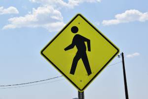 daytime pedestrian sign near power line