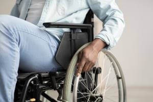 person pushing self in wheelchair