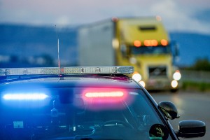 police car attending scene involving tractor trailer