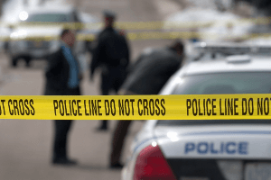 blurred day image of emergency vehicles and crew at accident scene