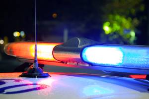 top of police car with lights on at night