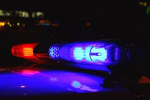 top of police car with lights on at night