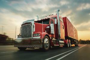 red semi truck passing by camera