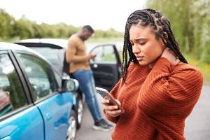 woman grabbing neck after car crash